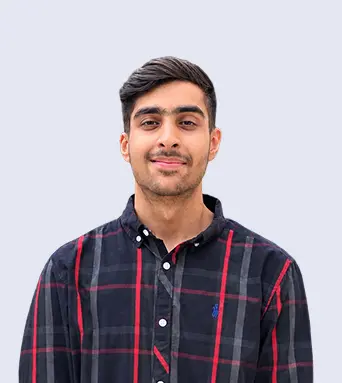 Muhammad Umer, AI Engineer at Report AI 365, smiling in a navy and red checked shirt against a pale grey background